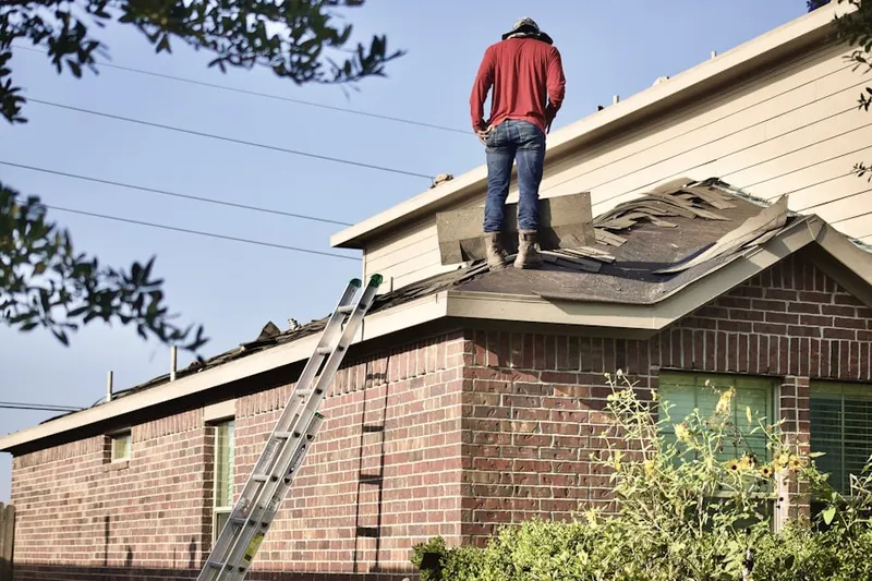 Professional roofer working on a residential roof in Wheatley
